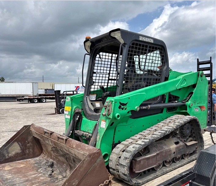 Compact track loader loaded on a trailer
